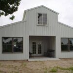 Image of bolt up galvanized steel barndominiums in Tucson, Arizona under a bright blue sky