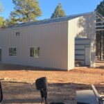 Modern galvanized steel cabins in Flowing Wells, Arizona, surrounded by picturesque desert landscapes and clear blue skies